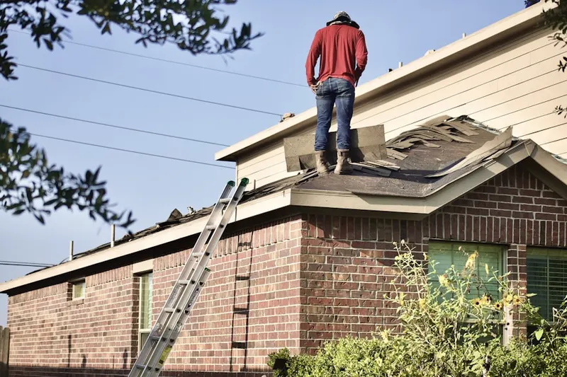 Professional roofer working on a residential roof in Elfers